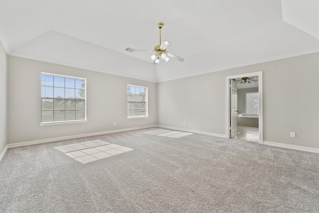 spare room with ceiling fan, crown molding, vaulted ceiling, and carpet flooring