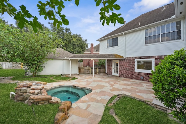 view of swimming pool with an in ground hot tub, a patio area, and a lawn