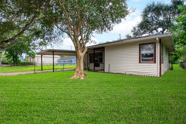 back of property with a yard and a carport