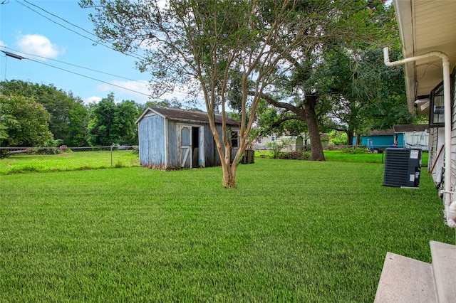 view of yard featuring a storage shed and cooling unit