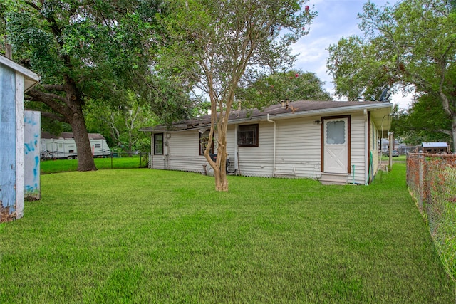 back of house with a yard