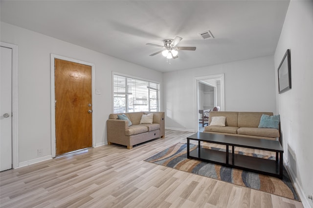 living room with light wood-type flooring and ceiling fan