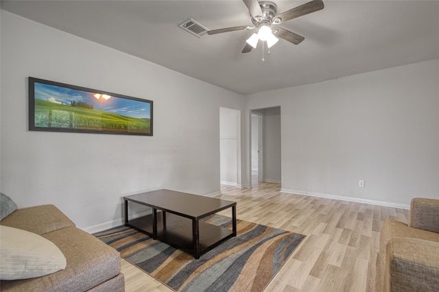 living room featuring ceiling fan and light hardwood / wood-style flooring