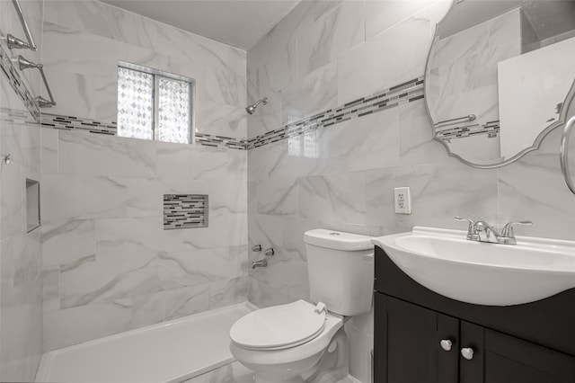 bathroom with toilet, vanity, and tile walls