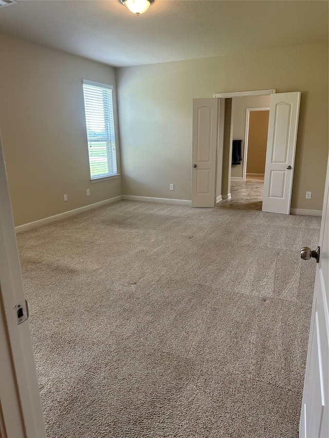 empty room featuring light colored carpet