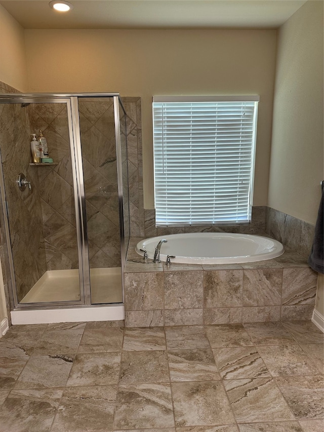 bathroom with tile patterned flooring and independent shower and bath