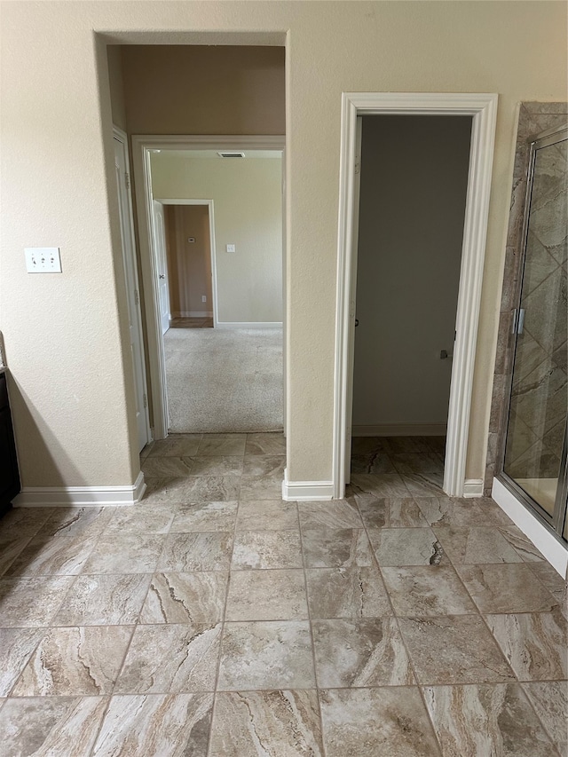 interior space featuring carpet floors, a closet, and a walk in closet