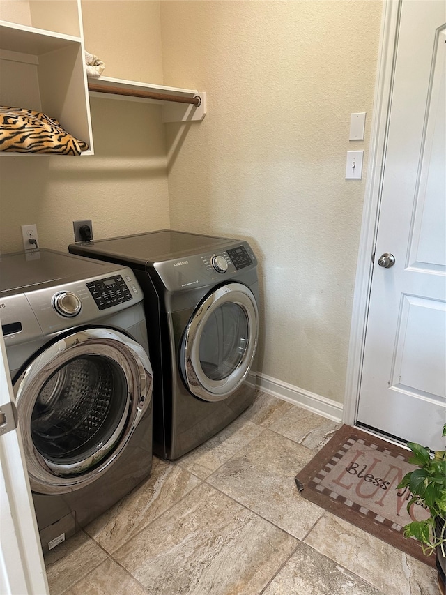 laundry area with independent washer and dryer and light tile patterned floors