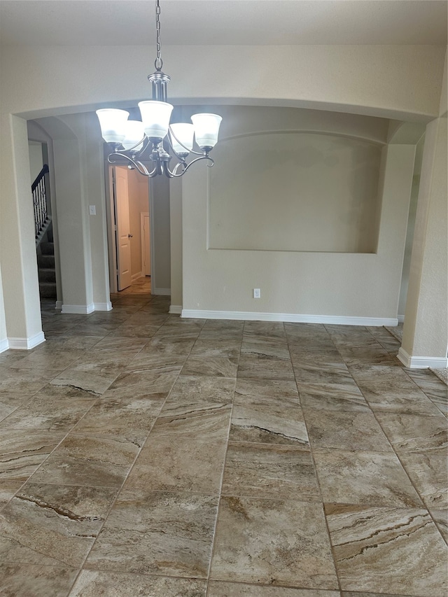 unfurnished dining area featuring an inviting chandelier and tile patterned floors