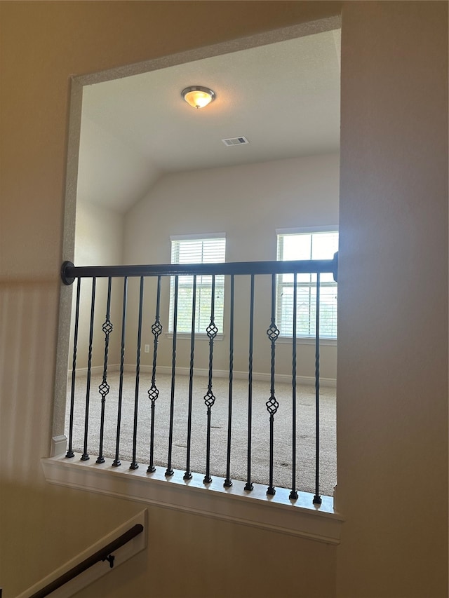 stairs with carpet flooring and vaulted ceiling