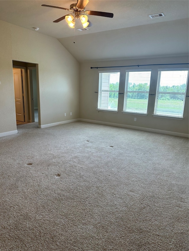 unfurnished room with ceiling fan, carpet, and lofted ceiling