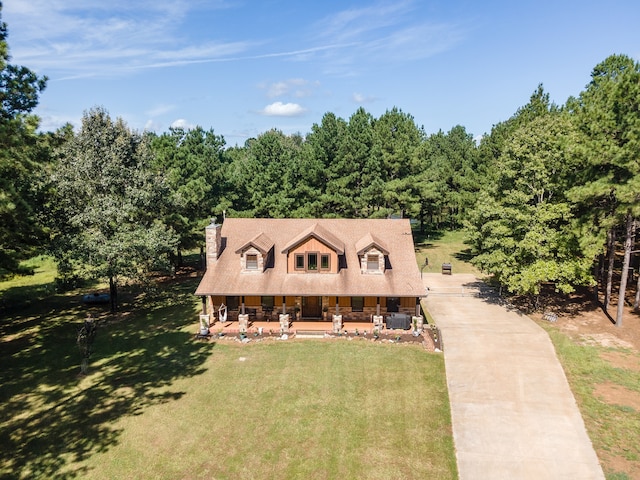 view of front of house featuring central AC unit and a front lawn