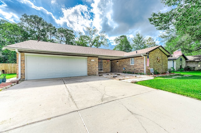 ranch-style home with a garage and a front yard