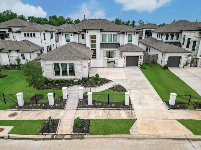 view of front of home with a front lawn, a garage, and an outbuilding