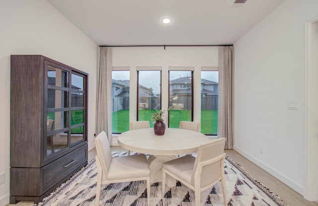 dining room with light wood-type flooring and plenty of natural light