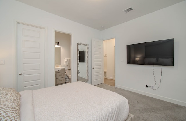 carpeted bedroom with ensuite bathroom