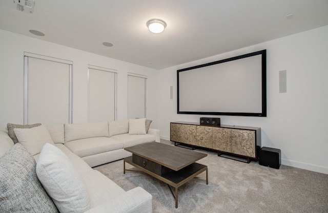 home theater room with light colored carpet