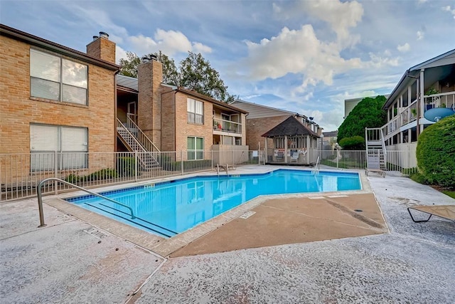 2110 Wilcrest Dr Unit 123, Houston, TX 77042 - community pool featuring a gazebo, stairs, and a patio area