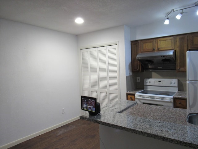2110 Wilcrest Dr Unit 123, Houston, TX 77042 - kitchen with white appliances, range hood, dark wood-type flooring, and dark stone counters