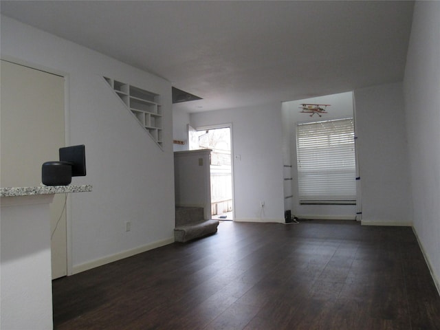 2110 Wilcrest Dr Unit 123, Houston, TX 77042 - unfurnished living room with dark wood-style flooring and stairway