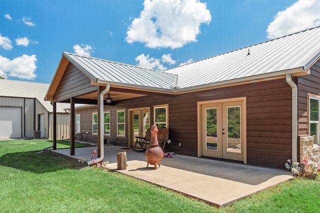 rear view of house with french doors, a yard, a patio, and central air condition unit