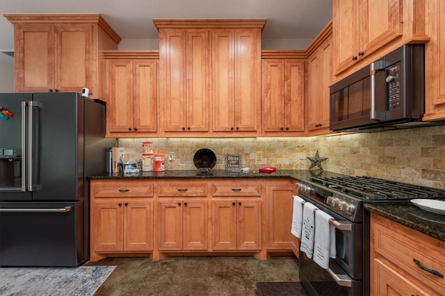 kitchen featuring backsplash, stainless steel appliances, and dark stone counters