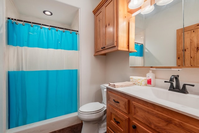 bathroom with a shower with curtain, vanity, and toilet