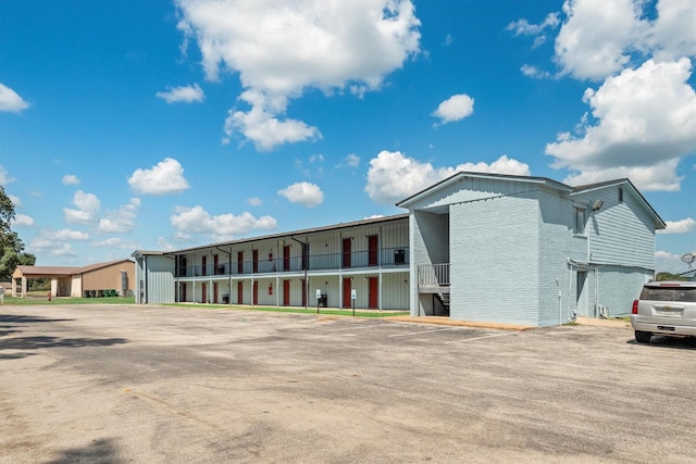 view of building exterior with uncovered parking