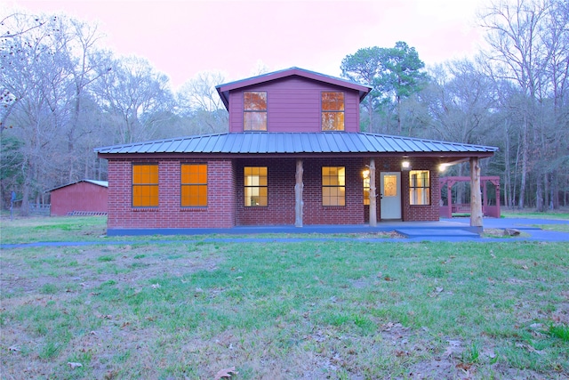 exterior space featuring a front lawn and covered porch