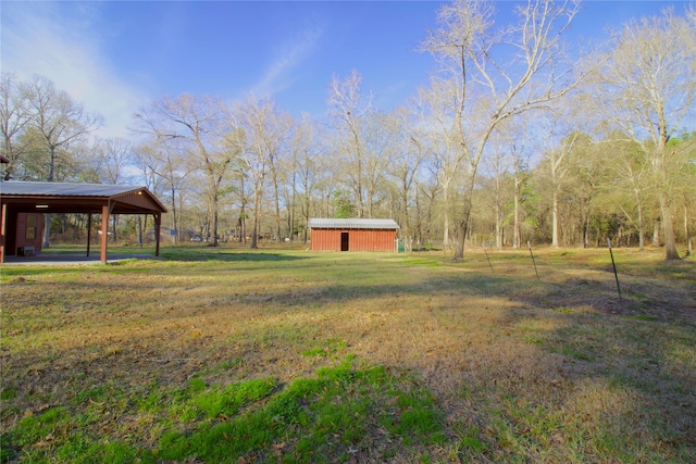 view of yard with an outbuilding and a carport