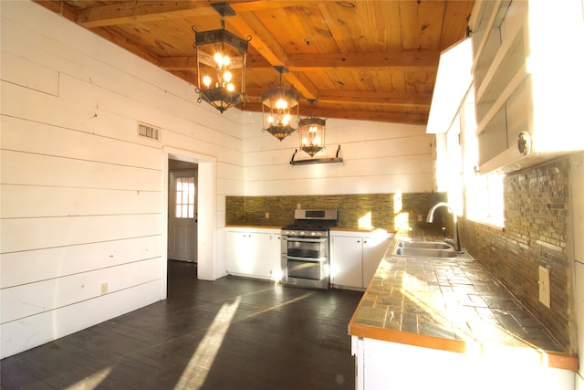 kitchen featuring vaulted ceiling with beams, decorative backsplash, wood ceiling, dark hardwood / wood-style flooring, and range with two ovens