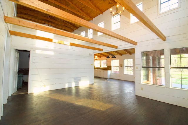 interior space featuring dark hardwood / wood-style flooring, high vaulted ceiling, and beamed ceiling