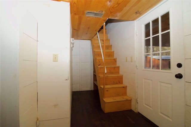 staircase with hardwood / wood-style flooring and wood ceiling