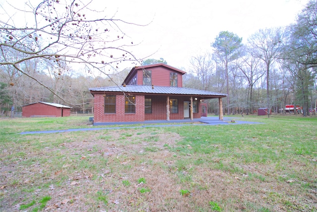 back of house featuring covered porch and a yard