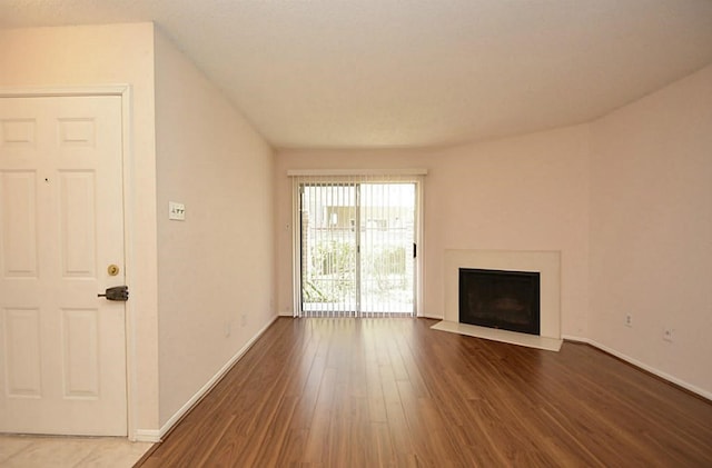 unfurnished living room with wood-type flooring