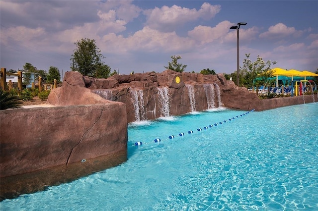 view of pool at dusk