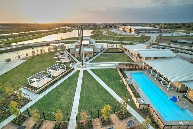 aerial view at dusk featuring a water view