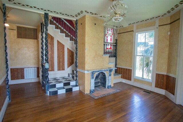 unfurnished living room featuring dark hardwood / wood-style flooring, plenty of natural light, and ceiling fan