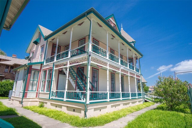 view of side of property with a balcony and a porch