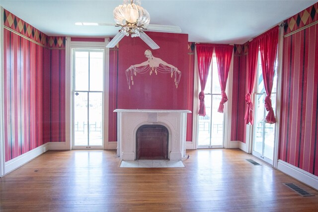 unfurnished living room featuring hardwood / wood-style flooring and ceiling fan