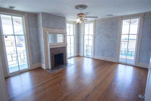 unfurnished living room with ceiling fan and wood-type flooring