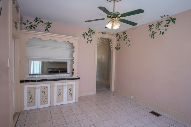 interior space with ceiling fan and light tile patterned floors