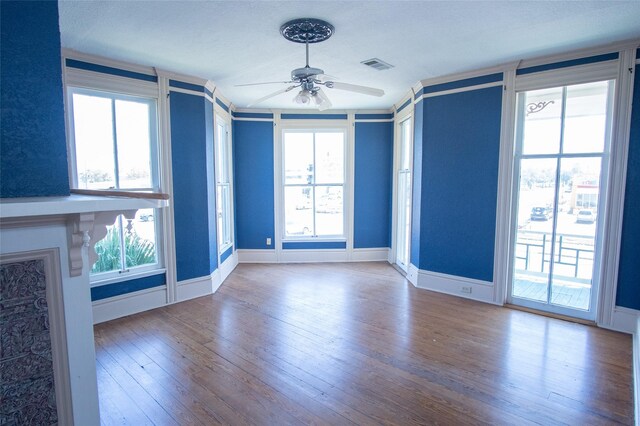 unfurnished living room with ceiling fan and wood-type flooring