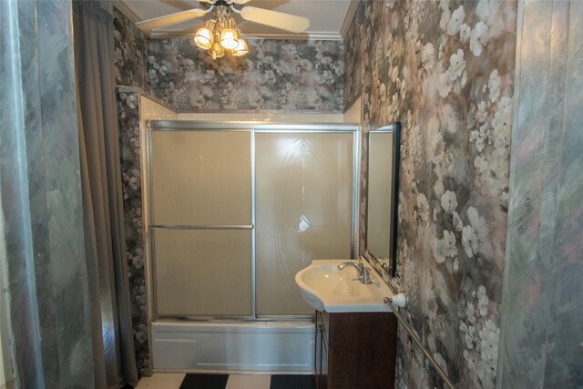 bathroom with ceiling fan, ornamental molding, shower / bath combination with glass door, and vanity