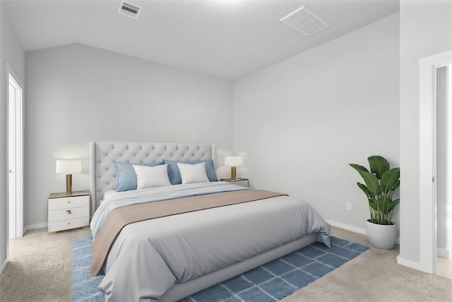 carpeted bedroom with lofted ceiling