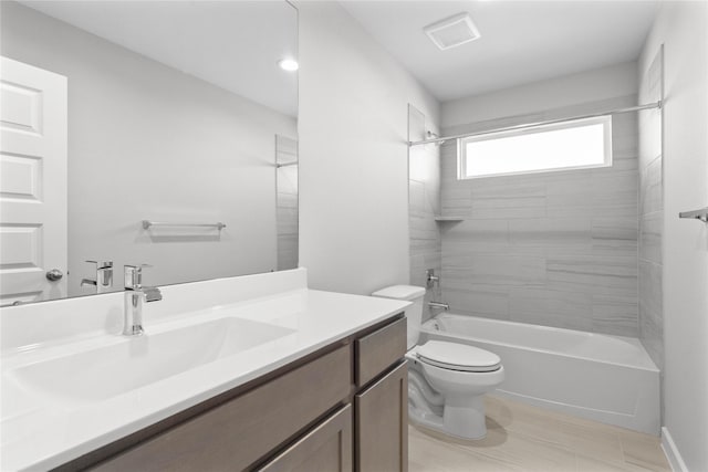 full bathroom with vanity, tiled shower / bath combo, and toilet