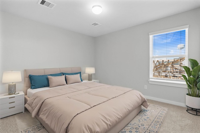 bedroom featuring light colored carpet