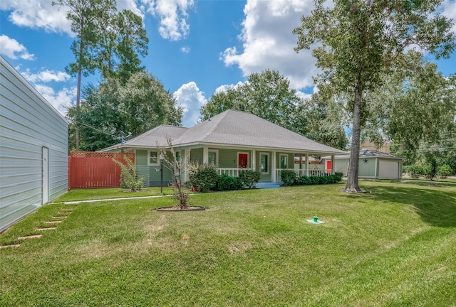 view of front of house featuring a garage, a porch, and a front yard