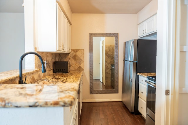 kitchen featuring white cabinetry, dark hardwood / wood-style floors, tasteful backsplash, light stone countertops, and stove