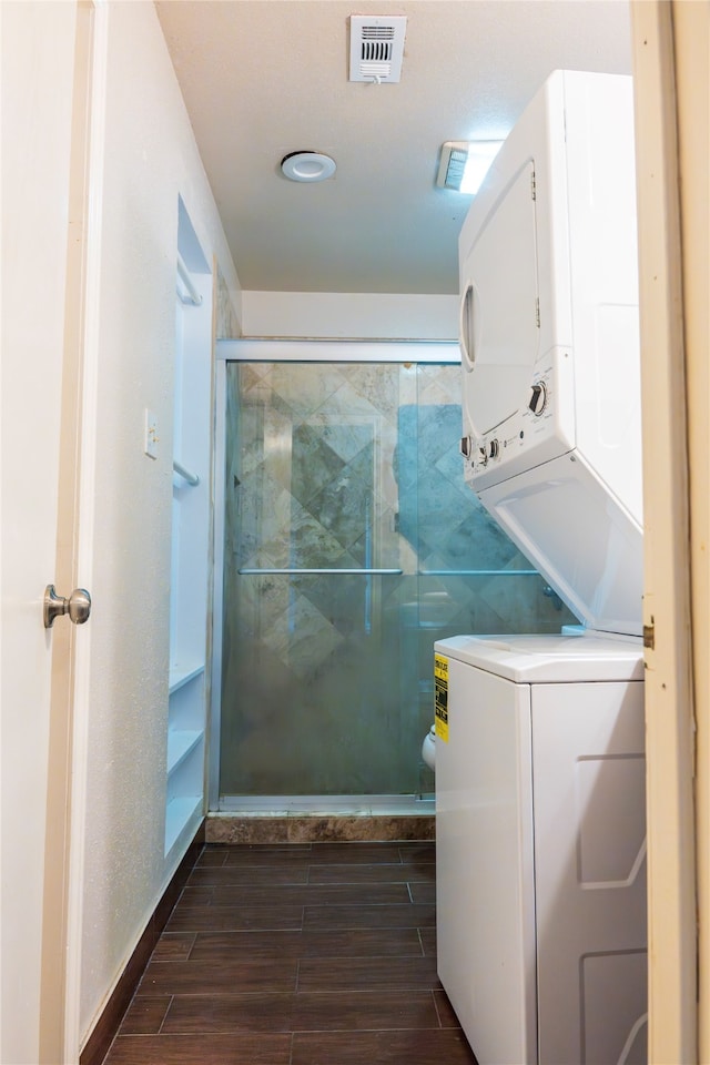 washroom featuring stacked washer and clothes dryer